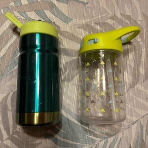 Teal insulated aluminum water bottle and Clear Water Bottles with green Lids